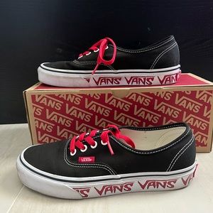 Black Vans with logo on sides